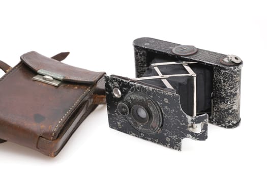 Old bellows film camera isolated on a white background