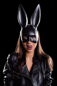A woman in a leather jacket with a hare mask on her face. High quality photo