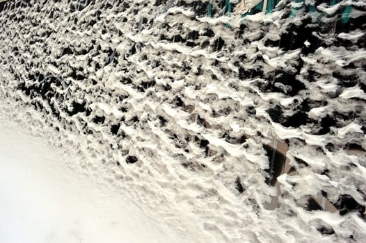 Fence covered with snow and ice . High quality photo