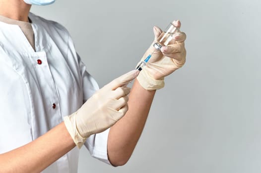 Nurse with syringe. Medical injection in hand. Vaccination kit. Covid-19 vaccine campaign. . High quality photo