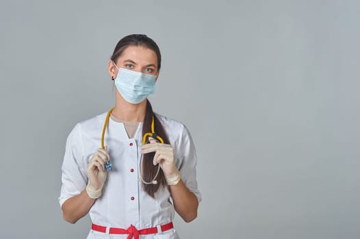 a doctor in a medical mask and a white coat with a stethoscope. High quality photo