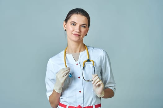 young doctor in white coat with a yellow stethoscope around his neck. High quality photo