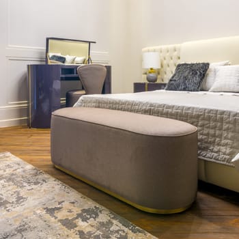 Studio shot of modern room with comfortable bed and bedside table with lamp