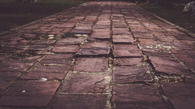Stone pavement texture in perspective. Pavement background. Abstract background of old cobblestone pavement close-up. Texture idea