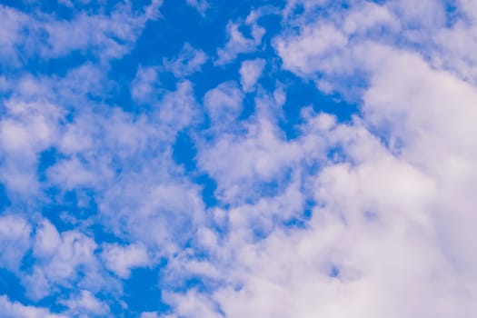 Beautiful white fluffy and cirrocumulus clouds on a blue sky background