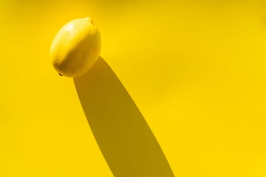Yellow fresh organic lemon on a yellow background in bright color