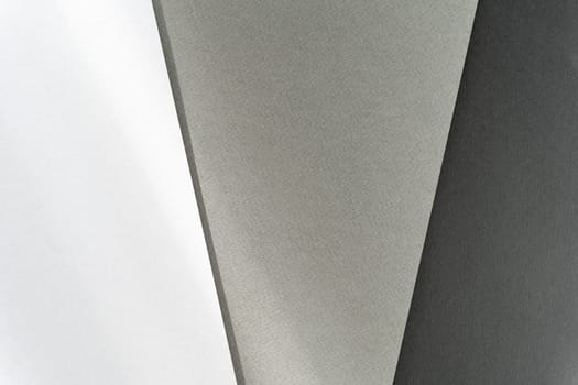 Abstract geometric backgrounds in white, gray, and black.