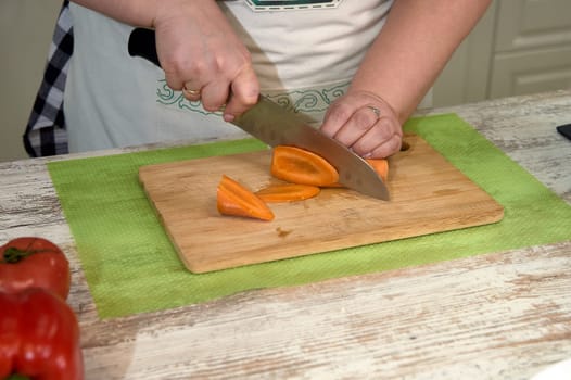 Slicing vegetables on a cutting board for cooking. High quality photo