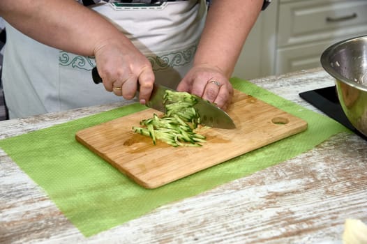slicing cucumber for salad, on a cutting Board. High quality photo