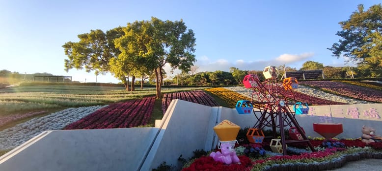 The San-Tseng-Chi Urban Park on a bright sunny day with colorful flower fields on the hillside under blue clear sky during Flower Festival, in Beitou District, Taipei City, Taiwan