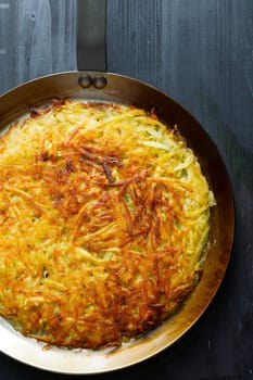 close up of a pan of golden swiss rosti fried potato pancake