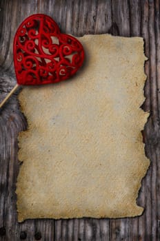 Valentine heart and old empty page on wooden background