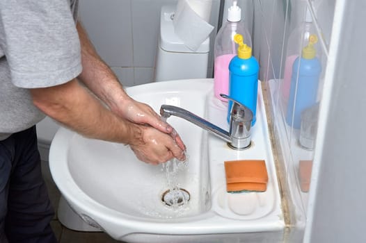 Washing your hands in the sink under the tap. High quality photo