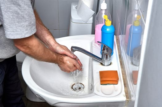 Washing your hands in the sink under the tap. High quality photo