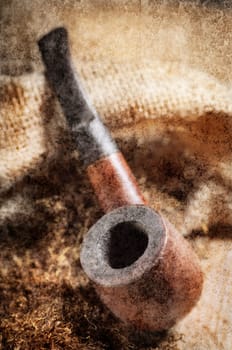 Vintage image of tobacco pipe on wooden background