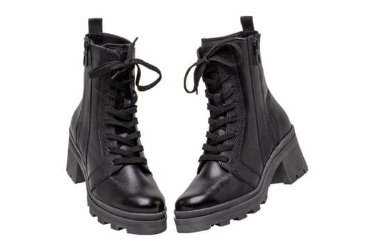 Womens boots and shoes. Closeup of female elegant black leather winter boots. Latest trends of winter shoe fashion for girls isolated on white background. Macro.