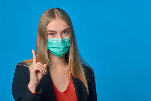 the girl in the mask on a blue background. High quality photo