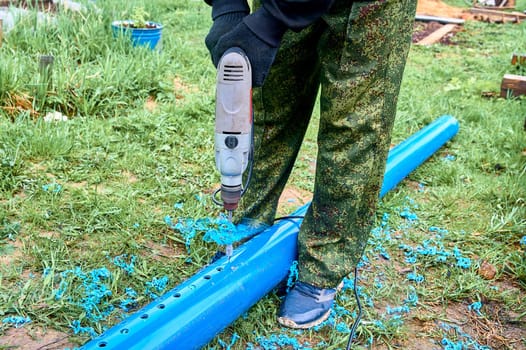 drill holes in a plastic pipe. High quality photo