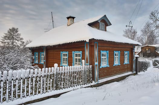 Village hut in winter at sunset in the countryside. High quality photo
