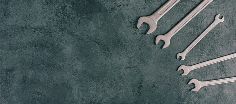 Wrenches tools on a dark textured background, copy space for text, repair and construction works, Labor Day