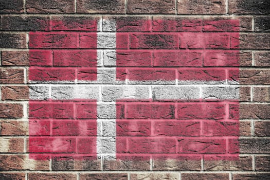 A Denmark flag painted on brick wall background