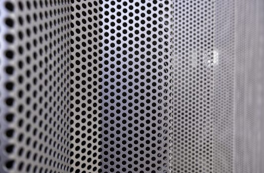 Detail of metal wall decorated with holes