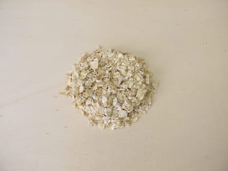 Fine rolled oats flakes on a wooden board