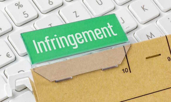 A brown file folder labeled Infingement