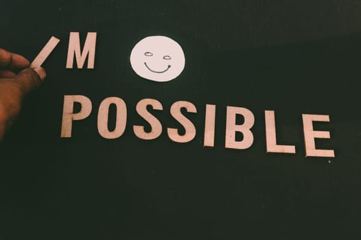 Impossible Means I’m Possible If You Know How To Begin - Man hand holding I letter to impossible an adding a smiley to say possible. Success and achievement determination concept.