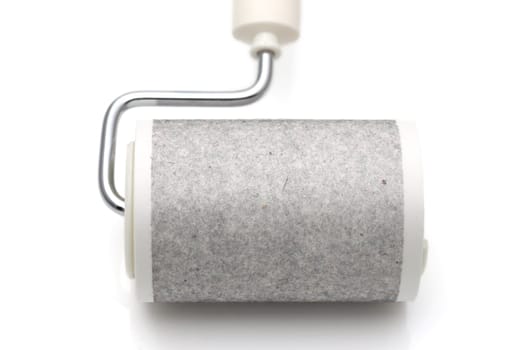 close up of used sticky roller cleaning, housework and housekeeping concept
