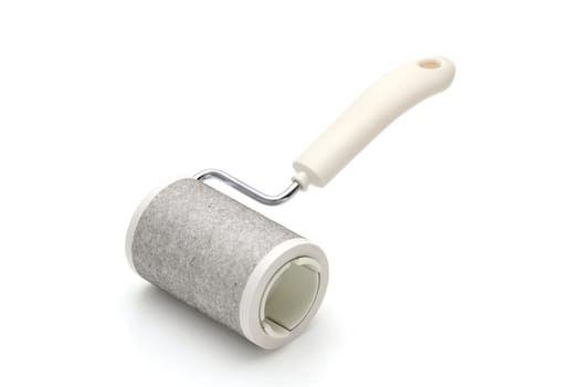 close up of used sticky roller cleaning, housework and housekeeping concept