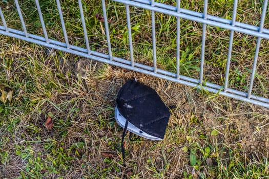 Medical mask on the sidewalk. Throwing a used face mask away on the street is wrong.