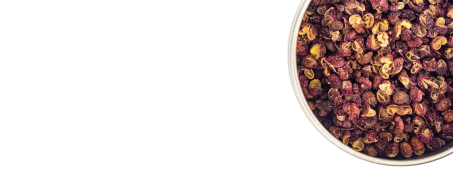 Szechuan pepper in a bowl isolated over white background