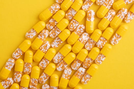 Top View from yellow pills over yellow background