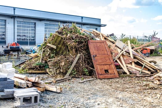 Rubble and green cuttings are ready for removal.