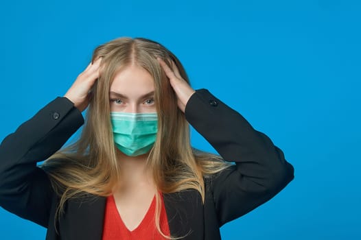 Business woman with a medical mask on her face holding her head. High quality photo