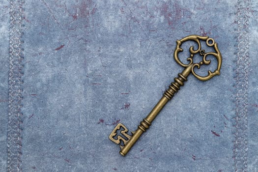vintage key on a grungy blue leather background
