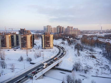 winter road to distant skyscrapers of a big city, bird's-eye view