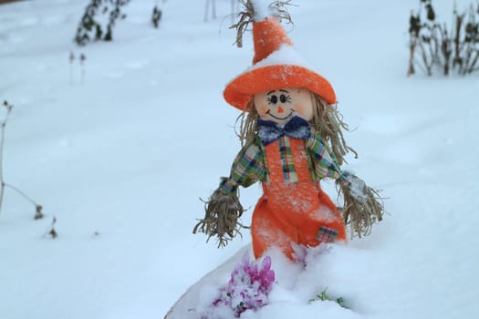 scarecrow on a field covered with deep snow winter landscape
