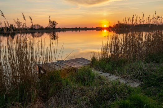 Fishing pier on the shore of the lake and sunset, Stankow, Lubelskie, Poland
