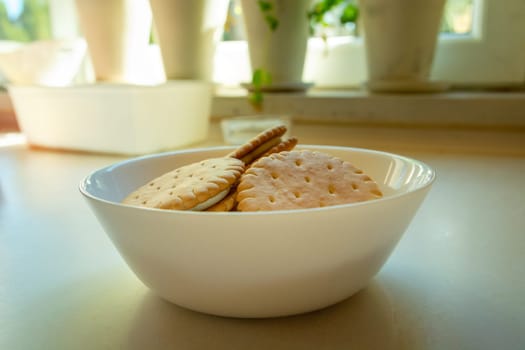Cream sandwich cakes in a white bowl on the countertop, close up