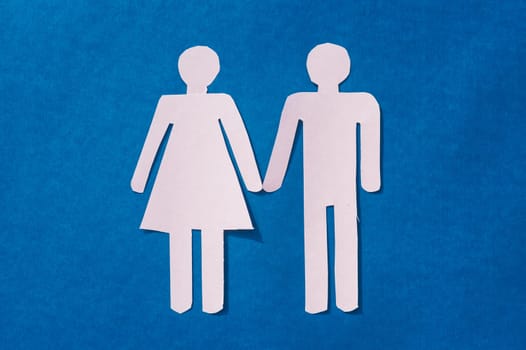Happy Human Couple Paper Craft Mockup on Blue background. Origami Papercraft decorative shapes and figure. Copy Space.