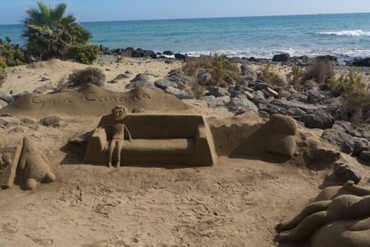 CRAN CANARIA, MELONERAS - 13. NOVEMBER 2019:.Sand sculptures on the beach of Meloneras, Spain with inscription Gran Canaria
