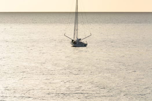 Yacht - catamaran in the tropical sea at sunset. Yachting / luxury sailing theme