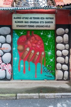 Istanbul, Turkey - April 18, 2017: Closed shop exterior with metal door covered with colorful graffiti at Hoca Tahsin Street, Karakoy district