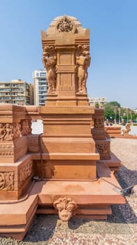 Cairo, Egypt- July 29 2020: 1945 Hindu statue, One of the Indonesian statues studding the external terrace of historical palace of Baron Empain with the palace at the far end, Heliopolis district