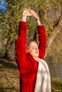 beautiful young woman enjoying sun in park