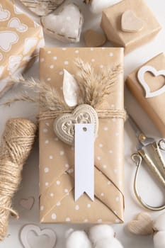 Valentines present with vertical gift tag, heart and pampas grass close up. Spring scene with blank label. Rustic, cottage chic or bohemian mockup, copy space