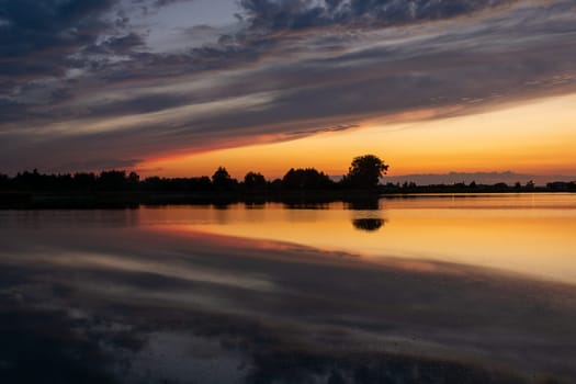 Reflection of clouds in the water after sunset, Stankow, Lubelskie, Poland