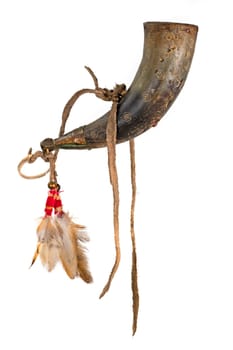 Old powder horn of the North American Indians made of horn decorated with deerskin and feathers isolated on white